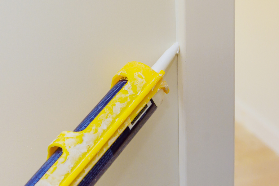 sealant being applied to door drame