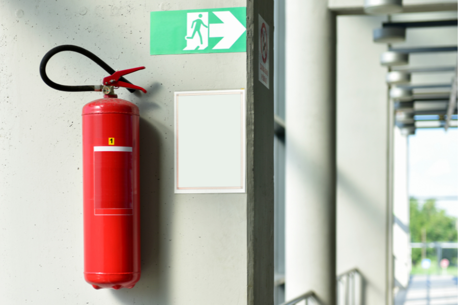 fire extinguisher next to exit sign
