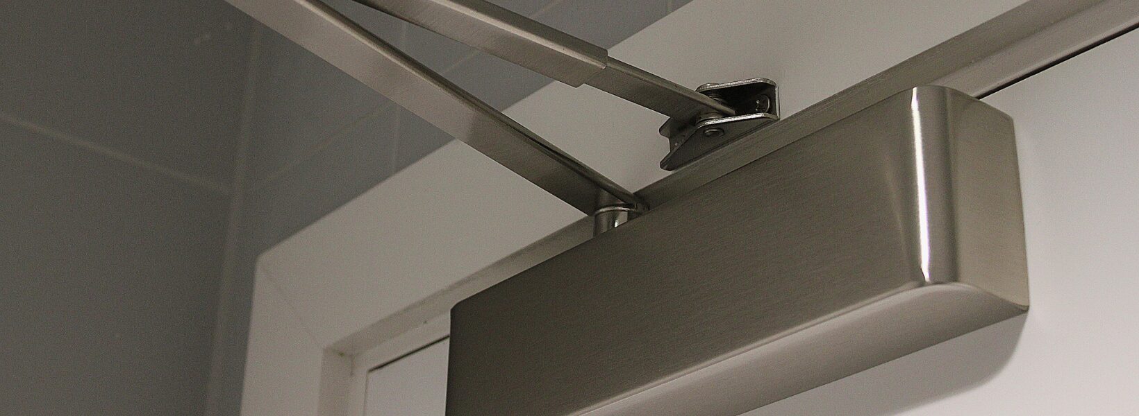 What_Door_Closer_Do_I_Need_Blog_Header Automatic fire door closer in silver